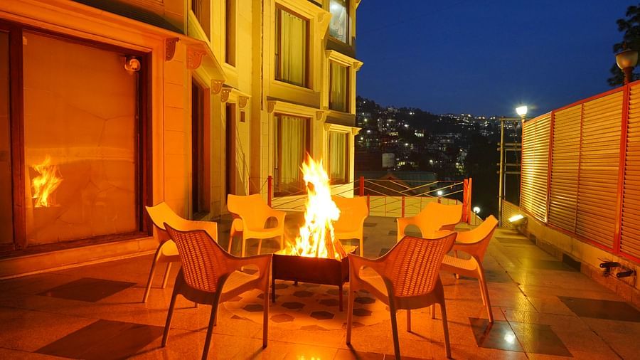 A bonfire with chairs arranged around it at DLS Hotels The Rock Castle